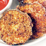 Air Fryer Eggplant Chips being dipped into a bowl of marinara sauce.