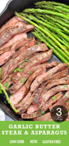Steak and garlic asparagus cooked in a black cast iron pan.