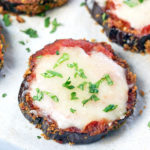 Eggplant Pizza garnished with parsley on a silver cookie sheet.