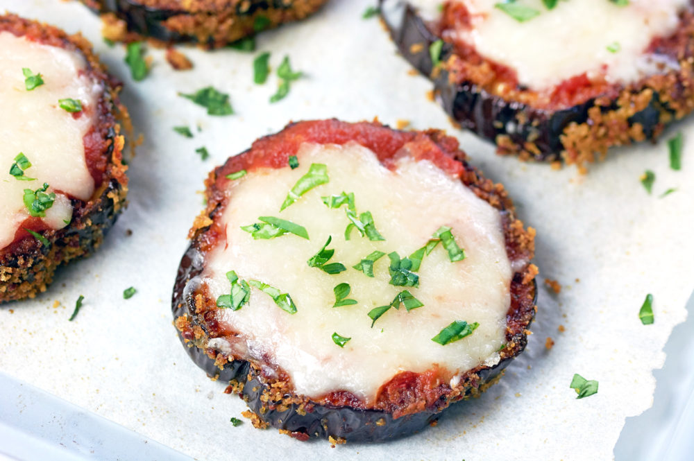 Eggplant Pizza garnished with parsley on a silver cookie sheet.