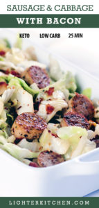 Up close picture of cabbage and sausage with bacon. Served in a large white dish.