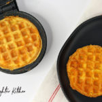 Cooked Chaffles on a Dash Waffle Maker and black plate.