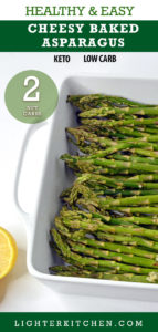 Raw Asparagus with Parmesan and lemon wedge in a white baking dish.