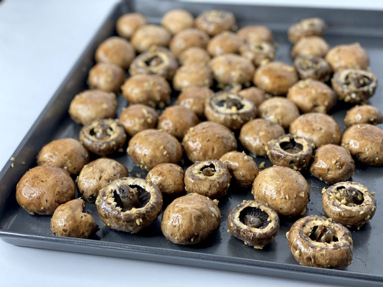 Oven Roasted Mushrooms on a black baking sheet.