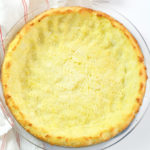 Baked Keto pie crust in a clear pie tin.