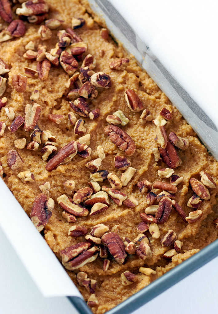 Raw pumpkin bread recipe in a silver bread pan.